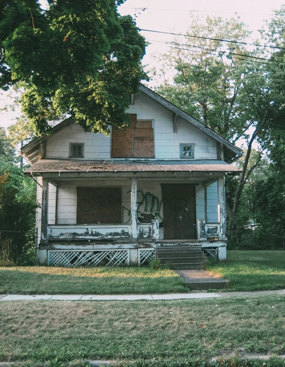 an old run down home with graffiti on it