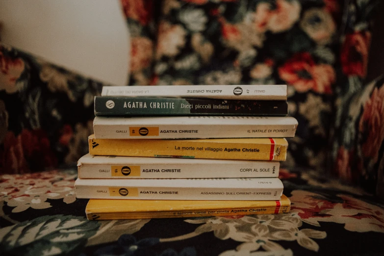 a stack of books sitting on top of a chair