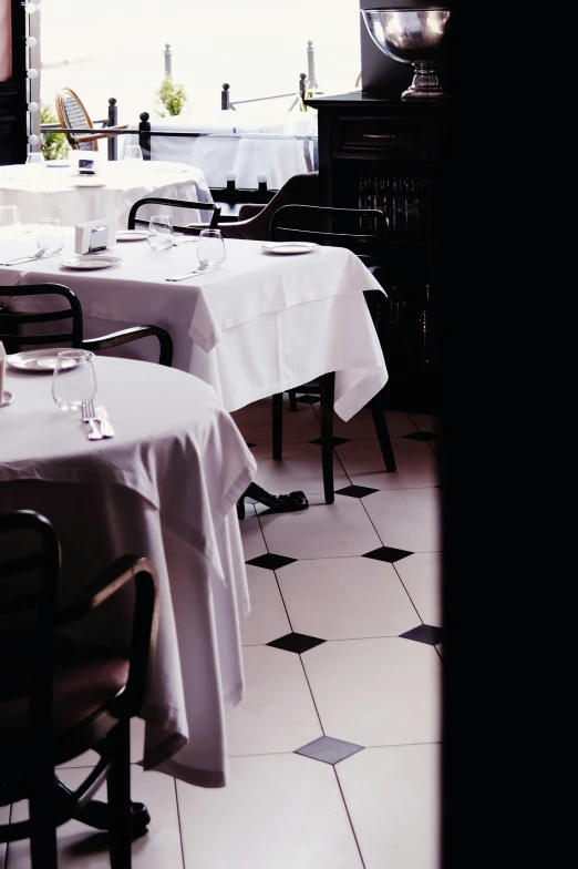 a dimly lit table and chairs are shown