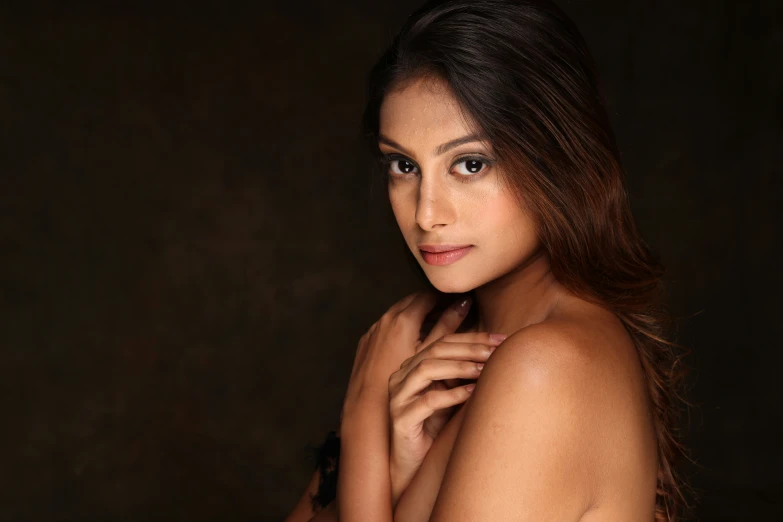 a girl posing for the camera in a po studio