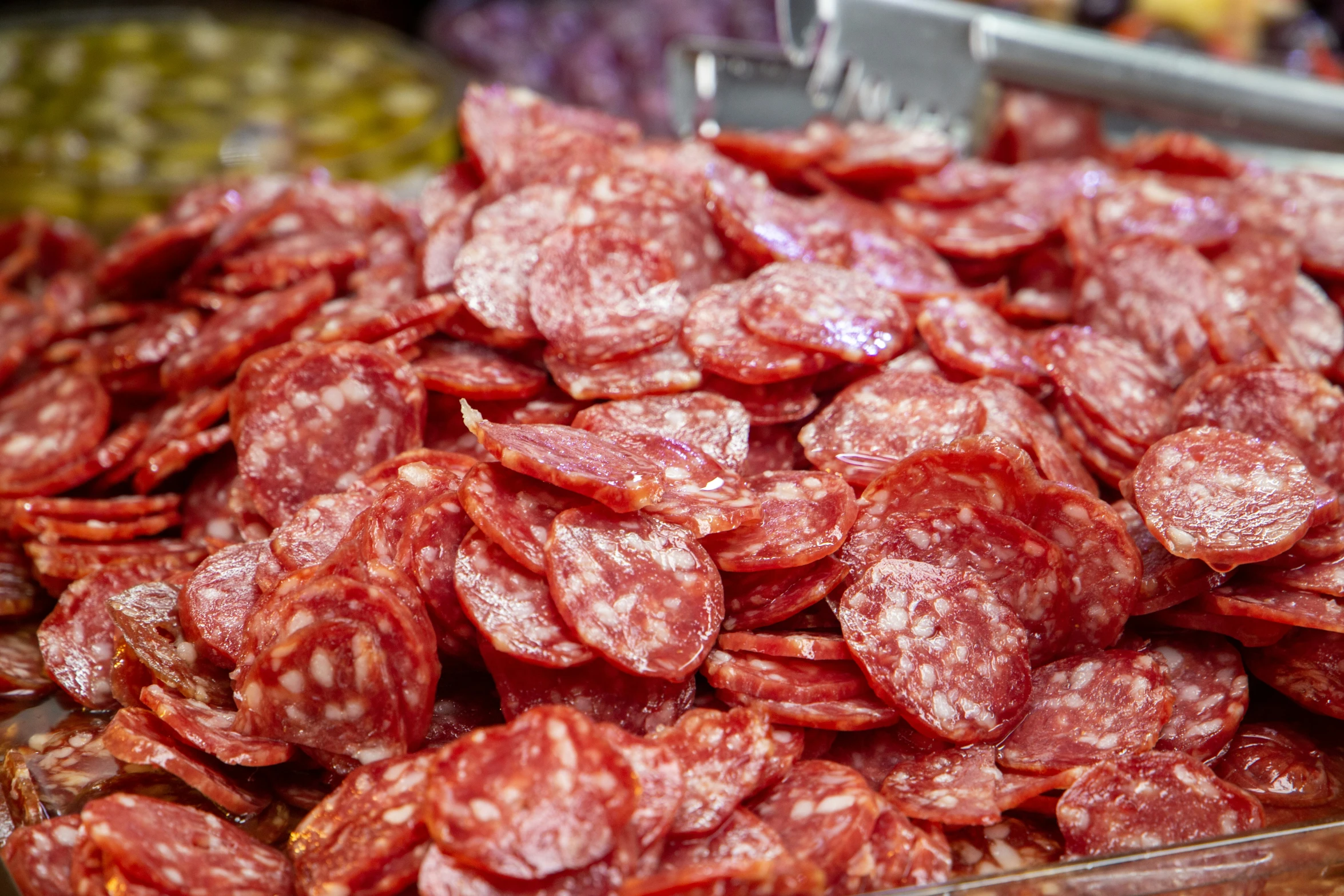 various large slices of sausage in a display case