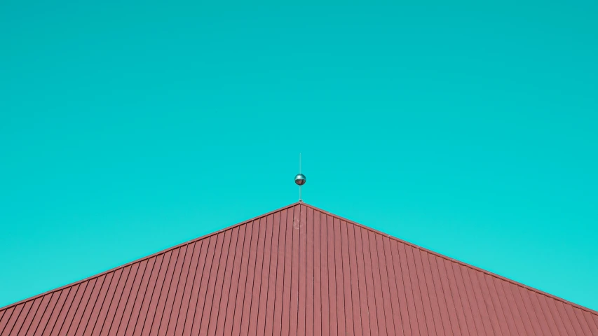 an image of a triangle shaped structure under a blue sky