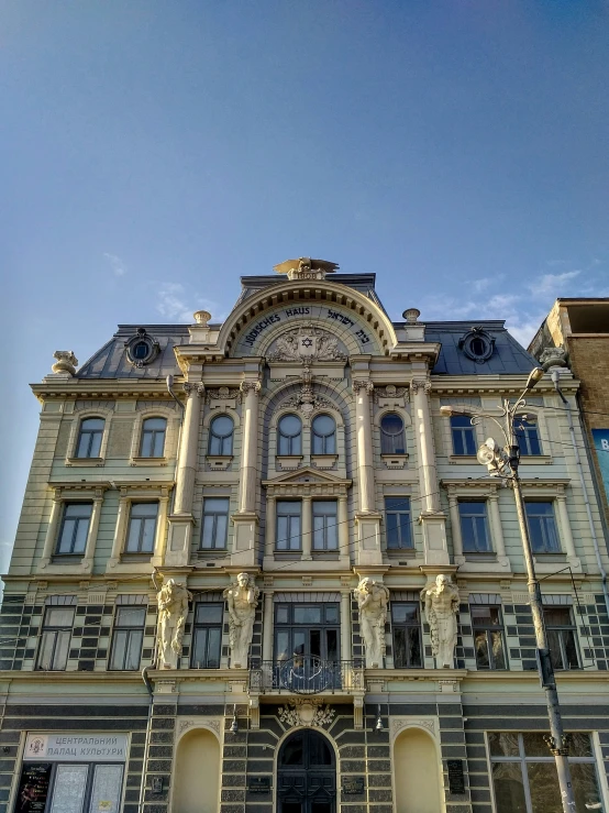 an old building is set against a partly cloudy sky