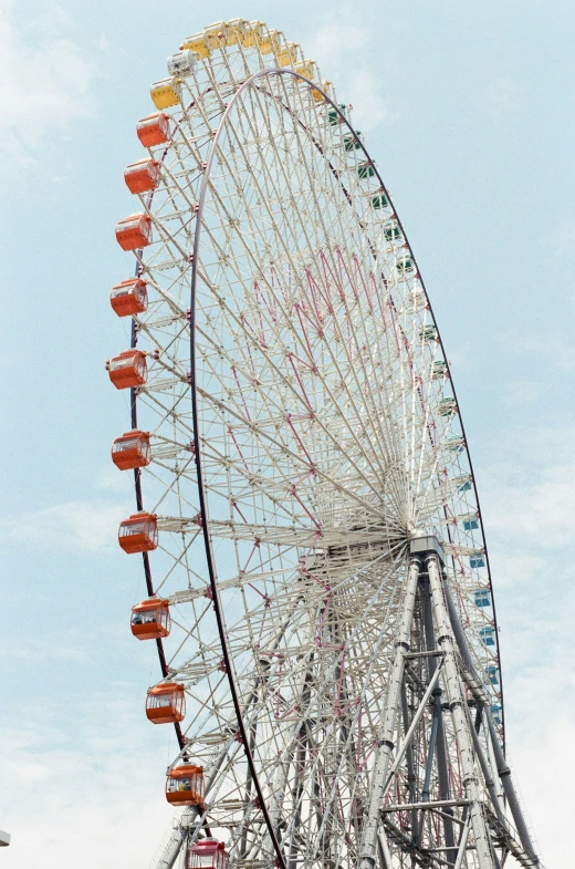 the large wheel is on display in front of blue skies