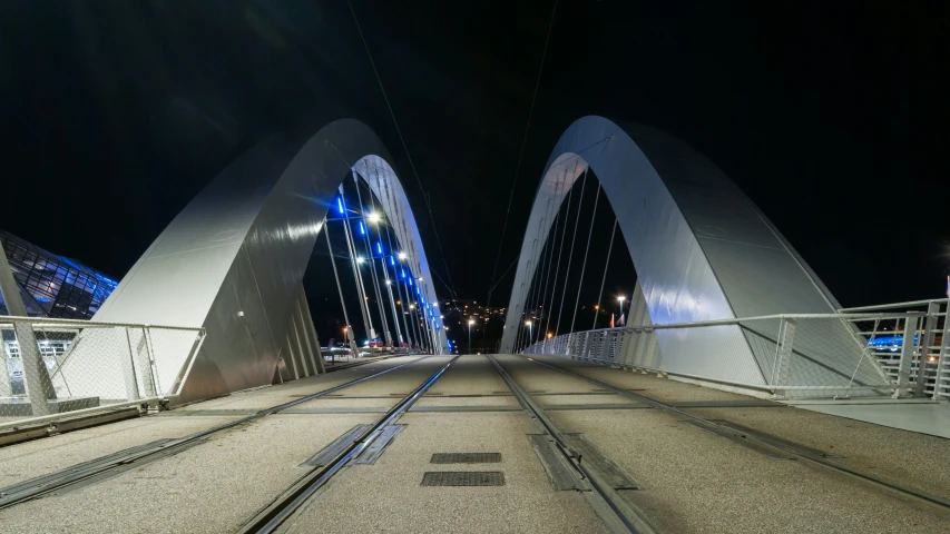 the lights are on at the top of the large bridge