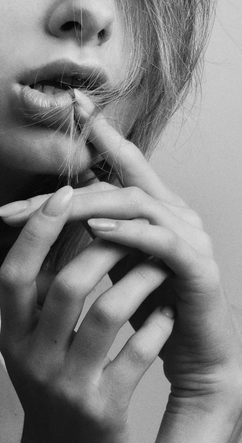 black and white image of woman with a cigarette in her mouth