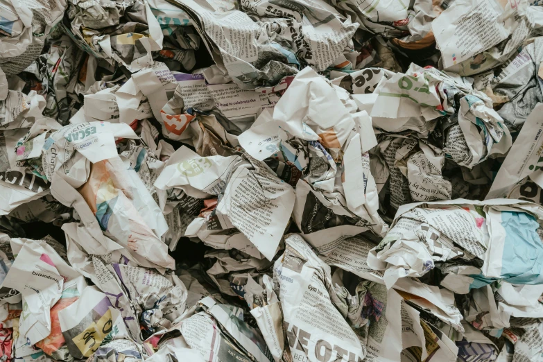 a pile of folded newspapers are shown in this image