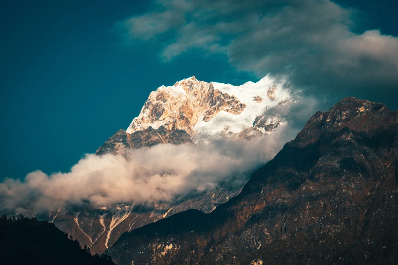 the clouds are gathering on a mountain top