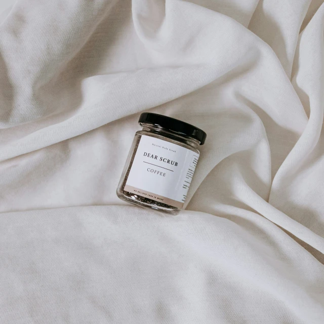 an image of the bed with a jar of honey on it