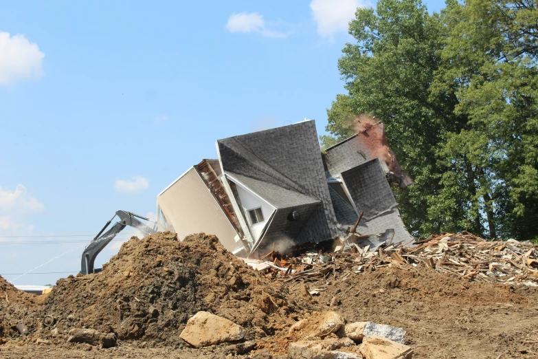 a pile of dirt with an old house piled on top of it