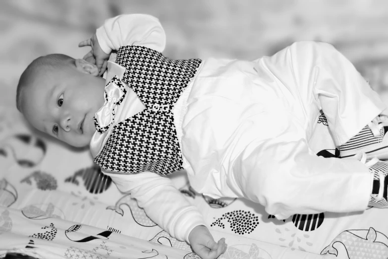 black and white pograph of an infant wearing a dress