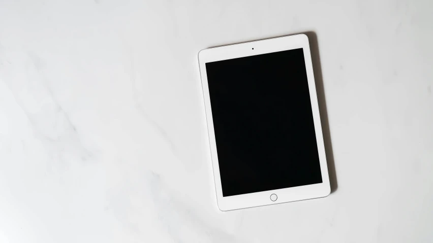 a white tablet sitting on top of a table