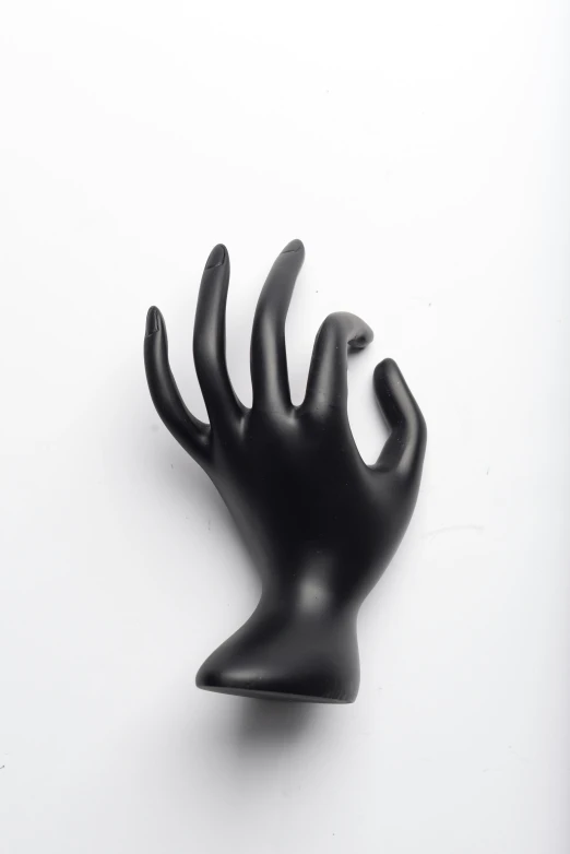 a plastic hand is resting on the wall