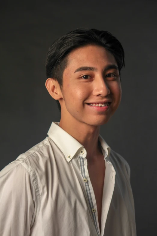 man in white shirt smiling at the camera