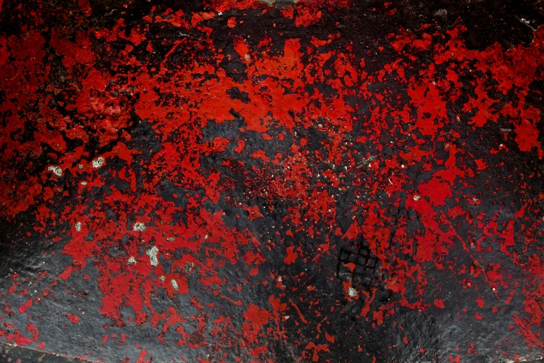 a black and red vase with some rust on the inside