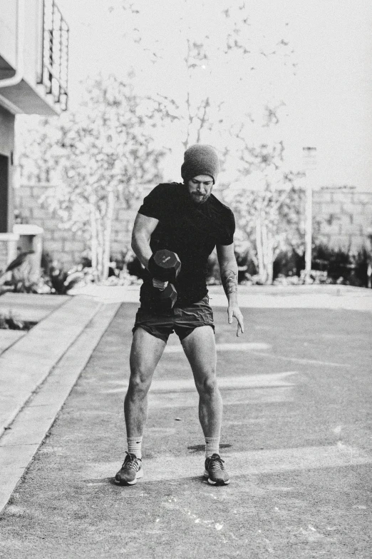 black and white pograph of a person in shorts and a beanie