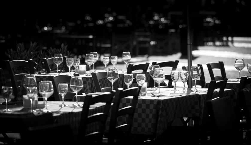 a long table with place settings and wine glasses on it
