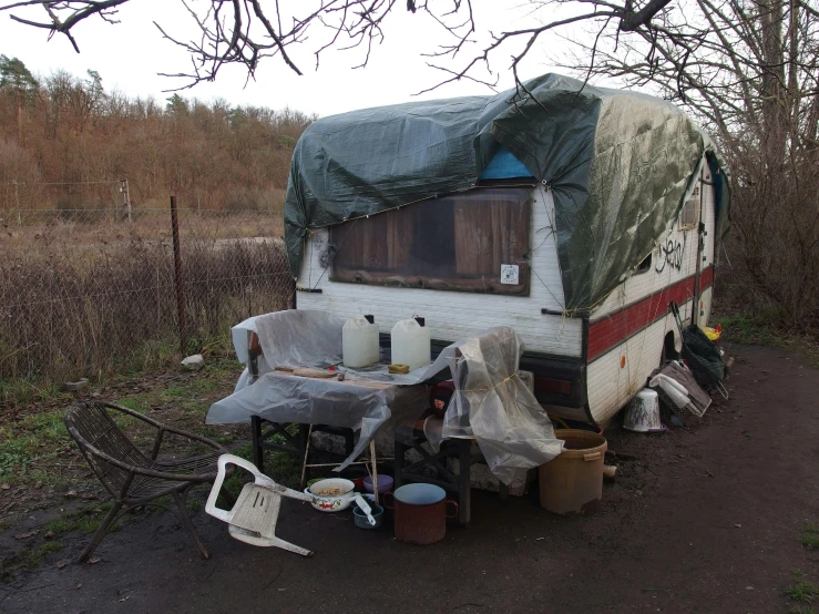 an outbuilding on the side of the road with some items outside