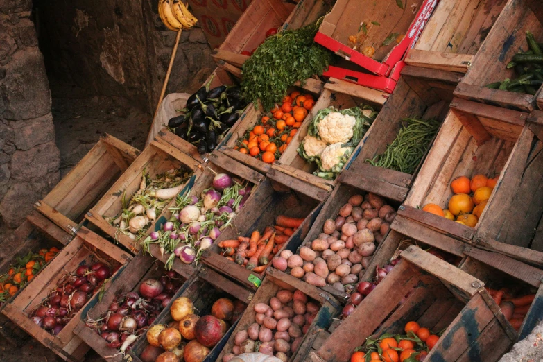 several crates filled with lots of different fruits and vegetables