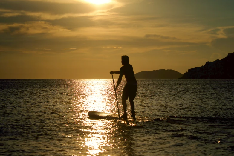 a person paddling in the ocean on a board