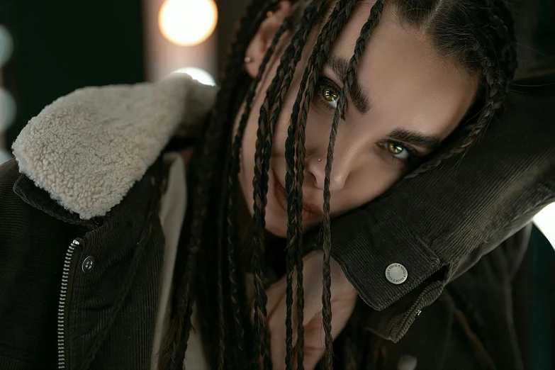 a man with dreads standing in front of the camera