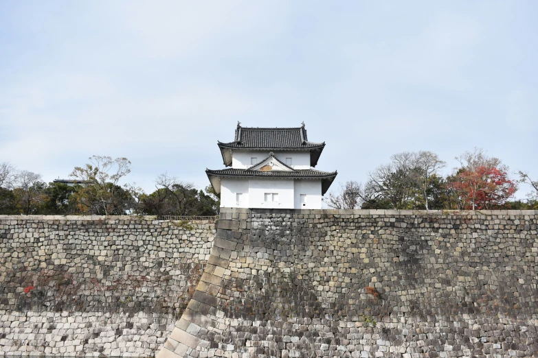 a wall and a tower near a large body of water