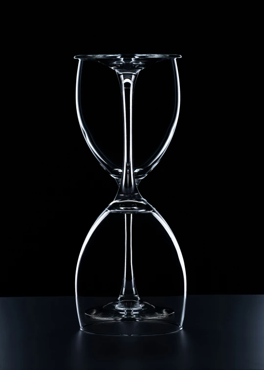 an empty glass sits on a dark table