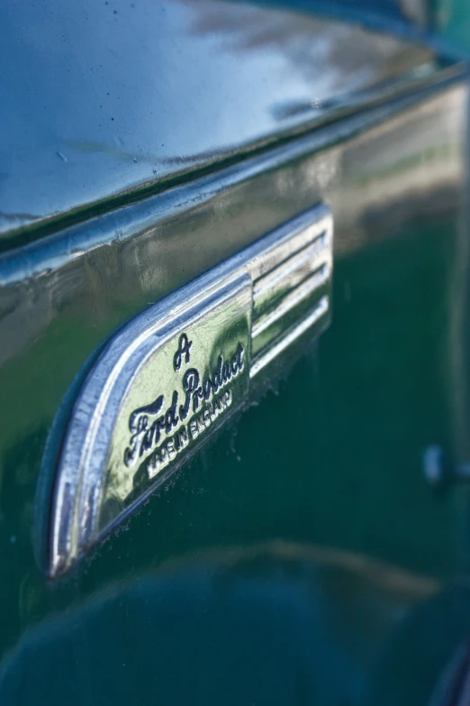 a blue car's emblem has a logo with the word and lettering