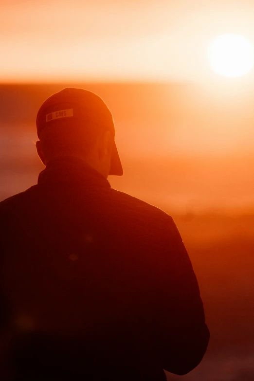 silhouette of person wearing a sun hat over body