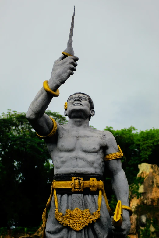 a man statue with a knife in his hand