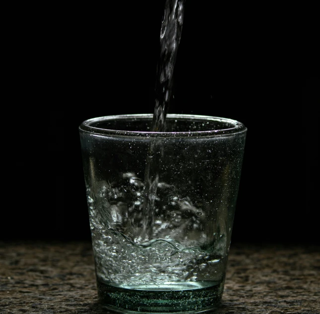 the water is being poured into a glass