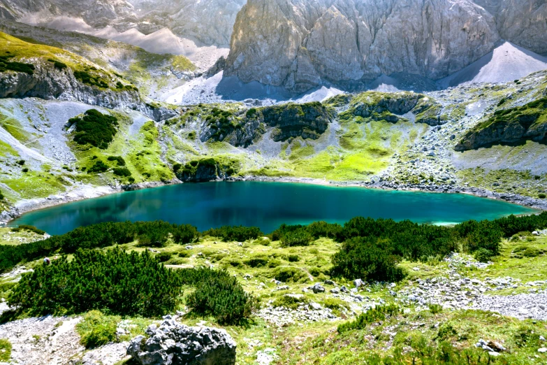 a very scenic place with green trees and a blue water