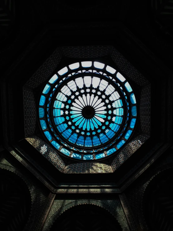 the round window has a circular pattern and blue light inside