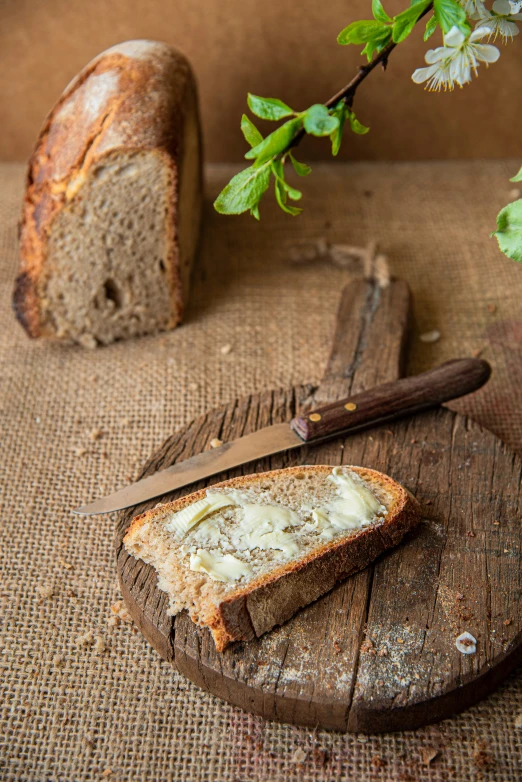 a bread on a table with a knife and er