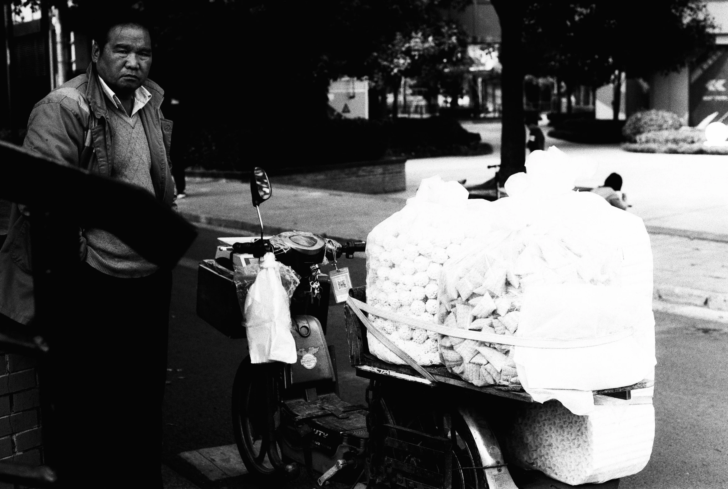 the man is standing next to the cart of food