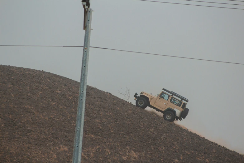 a jeep off roading in the middle of a hill