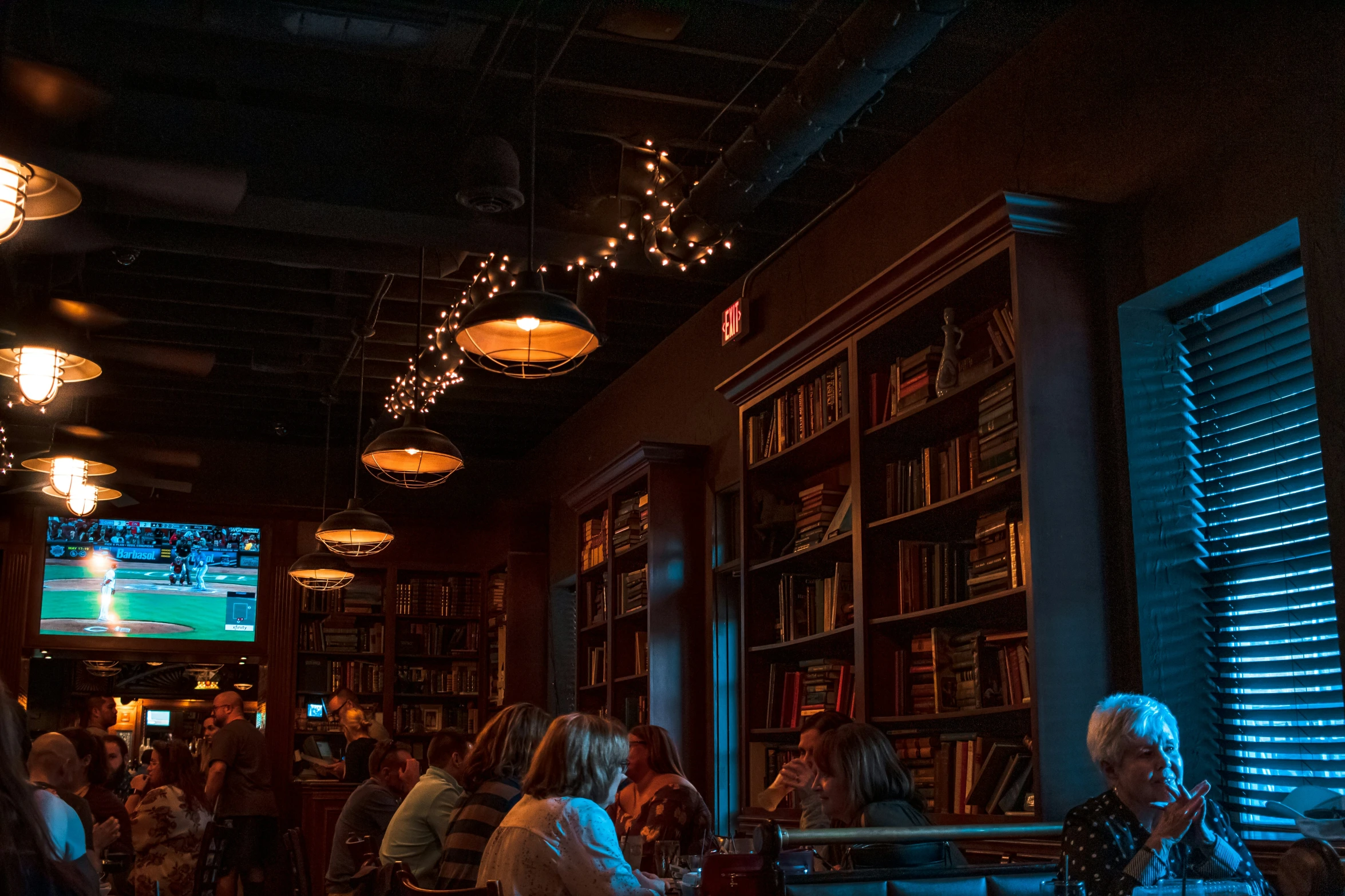 people sitting in a liry filled with books