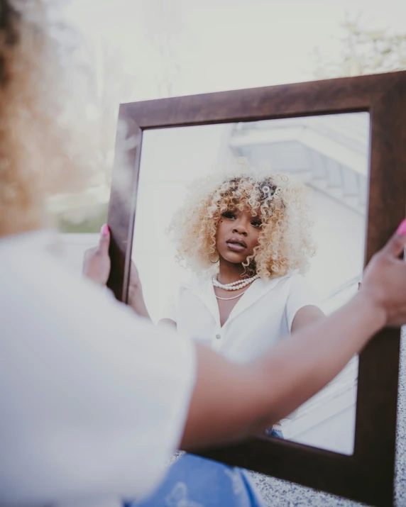 a woman looking at herself in the mirror