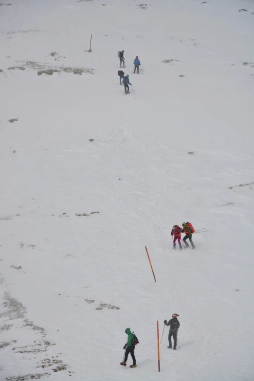 the skiers are heading up the hill on their skis