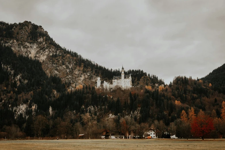 an abandoned church on a small hilltop near some mountains