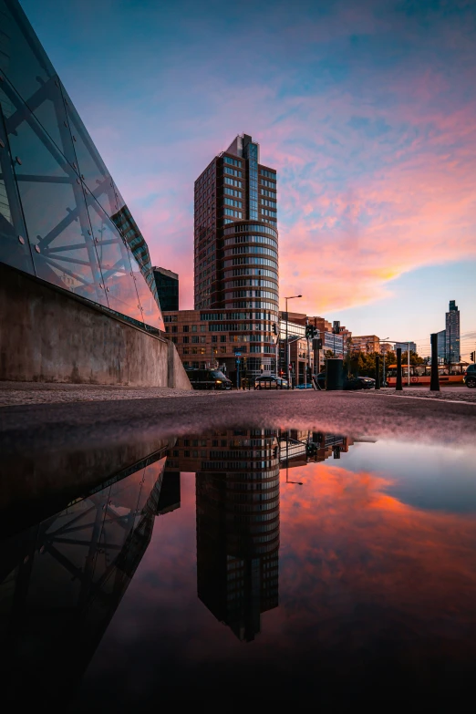 a sunset reflects in the water and skyscrs