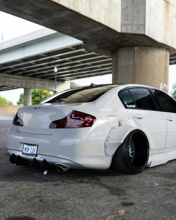 white car with black tires parked on the side of the road