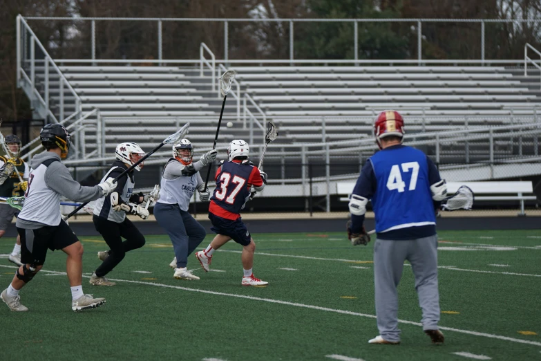 the lacrosse players are playing together on the field