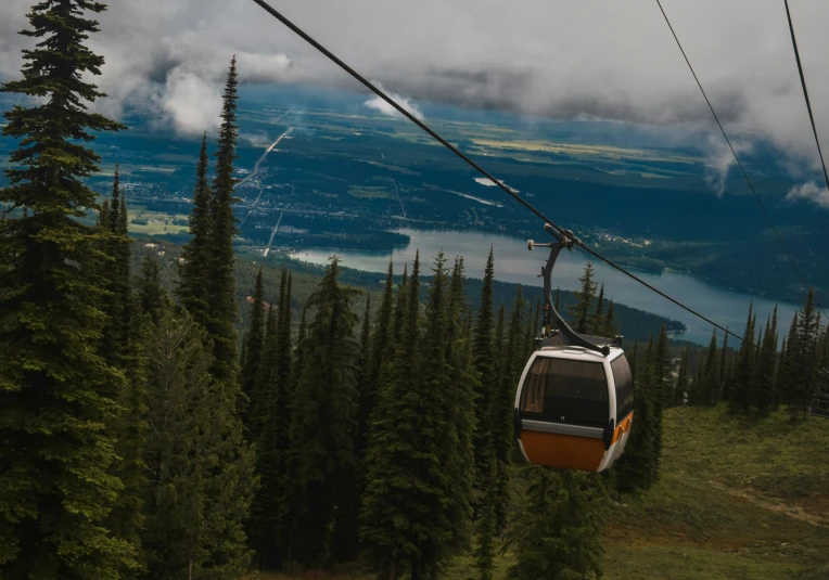 a view of a ski lift going through the mountains