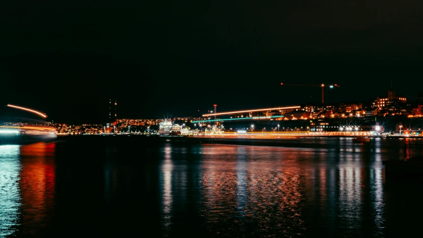 city lights on the water at night in a city