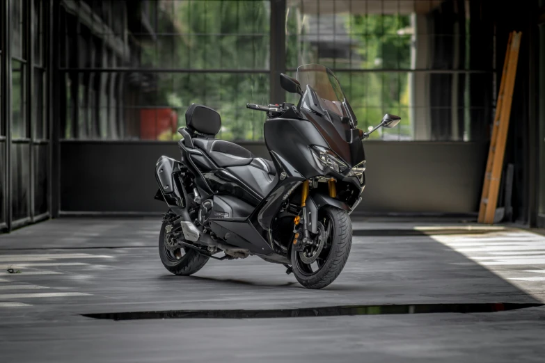 a black motorcycle parked on top of a driveway