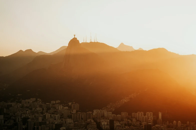 a skyline view at sunset with mountains in the distance