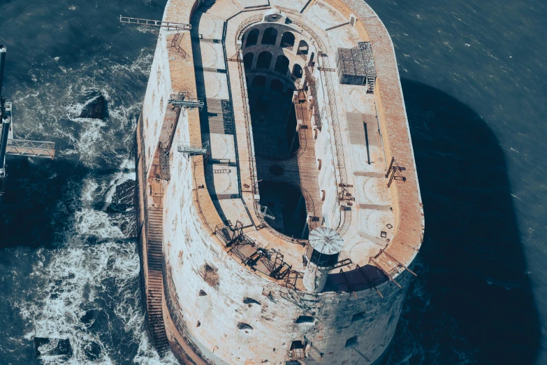 an aerial view of an old ship in the water