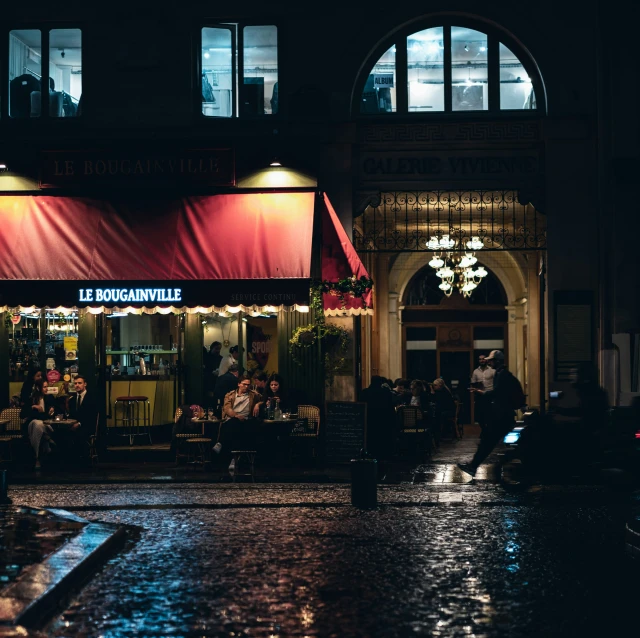 a restaurant sits on the street corner during the rainy