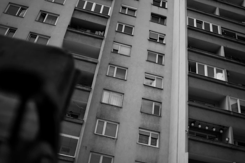 a tall building with lots of windows next to a street sign